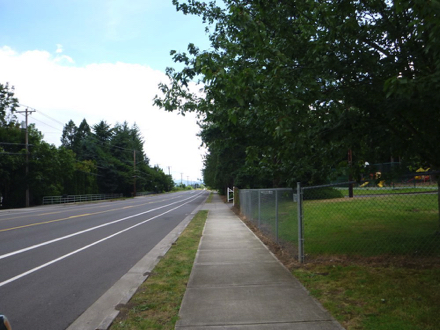 Entrance to the park is at 24300 NE Halsey St – sidewalk and bus stop in front